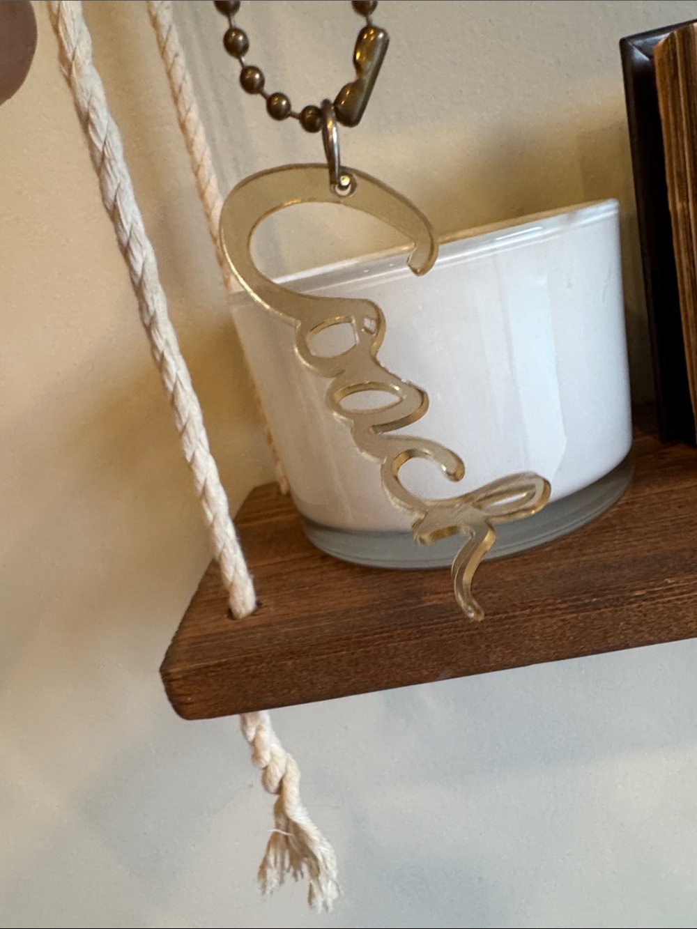 Coach gold-tone hanging script logo wall charm